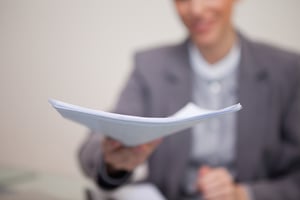 Paperwork being handed over by young businesswoman