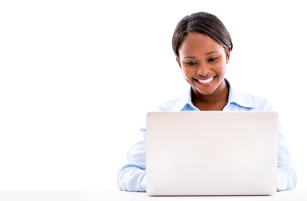 Business woman working online on a laptop computer - isolated